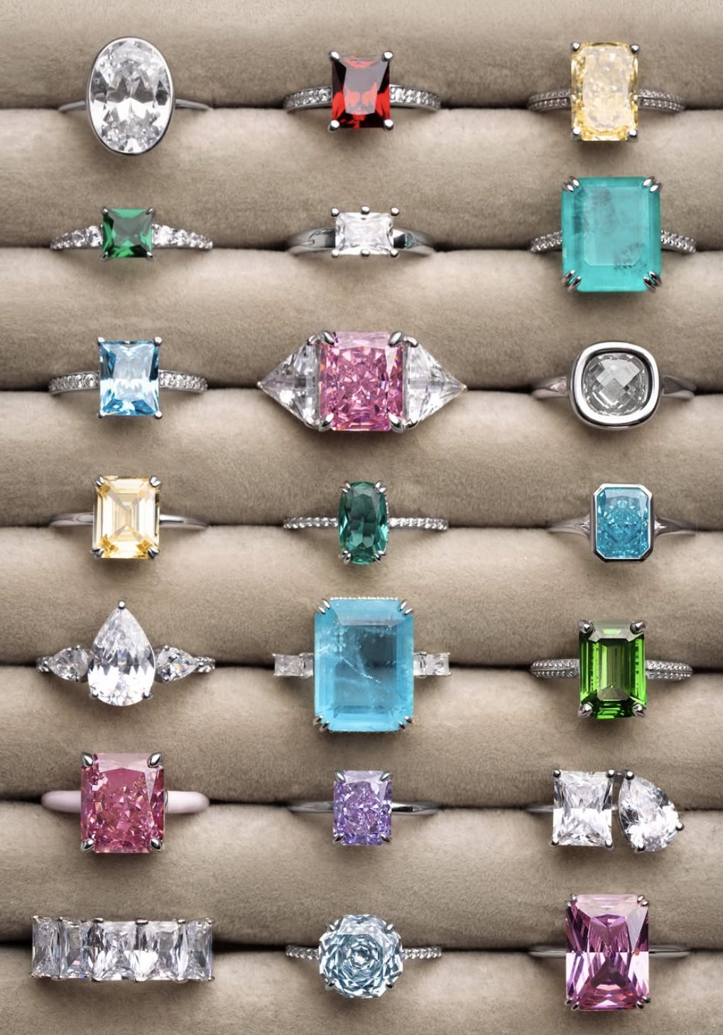Tray of rings set with coloured and clear stones