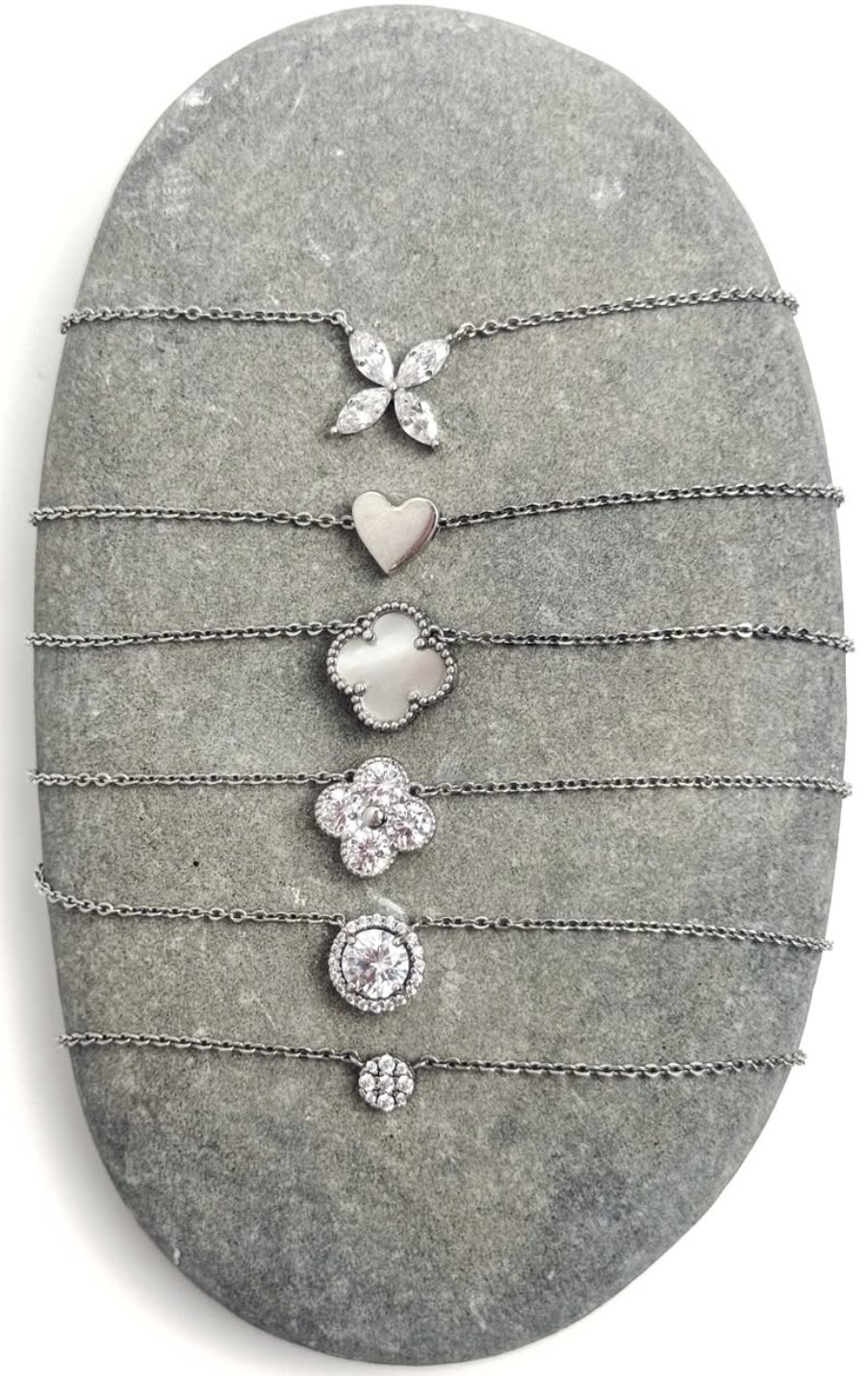 Fine chain pendants laid on a stone