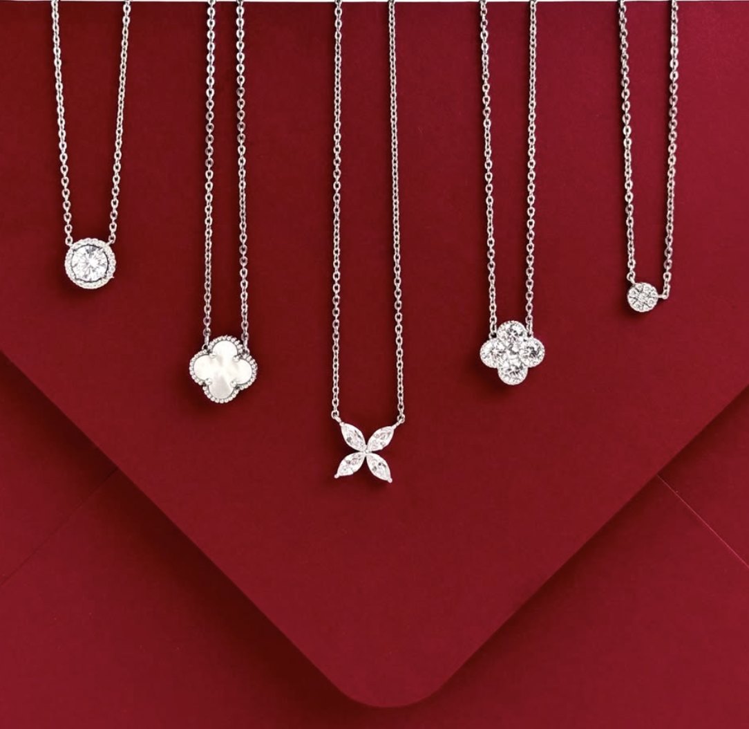 Five pendant necklaces in halo, clover and marquise designs